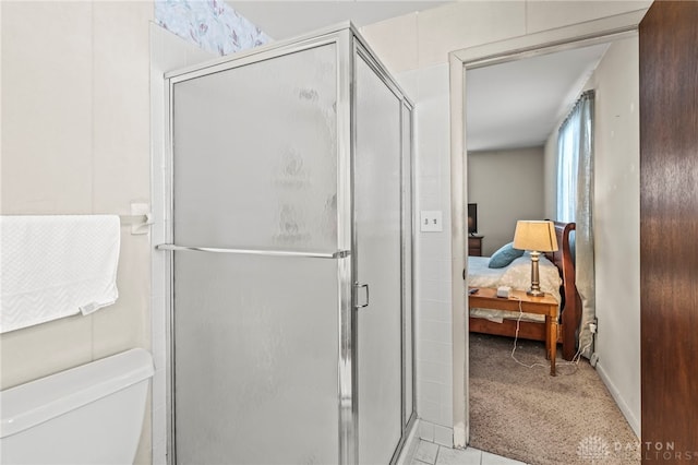 bathroom with toilet and a shower with shower door