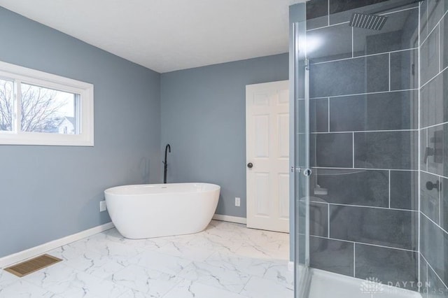 bathroom featuring separate shower and tub