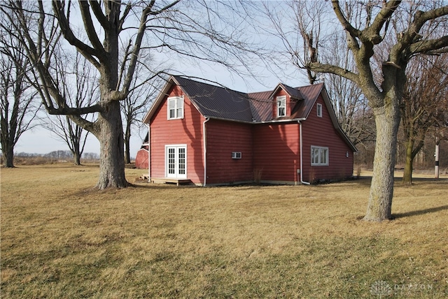 view of side of property featuring a yard and french doors