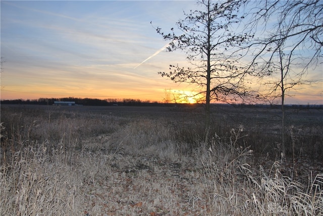 nature at dusk featuring a rural view