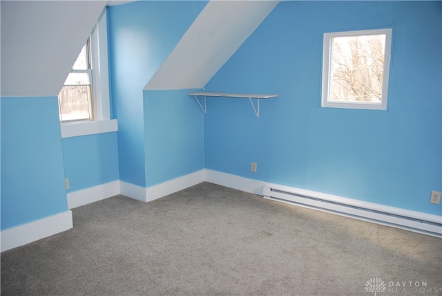 additional living space featuring a baseboard radiator, carpet floors, and lofted ceiling