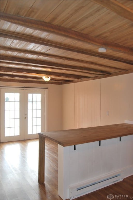 bar with french doors, beamed ceiling, wooden ceiling, hardwood / wood-style flooring, and baseboard heating