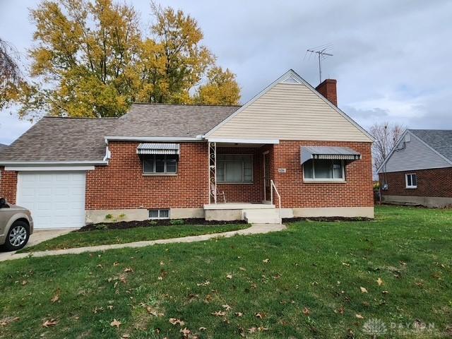 view of front facade with a front yard and a garage