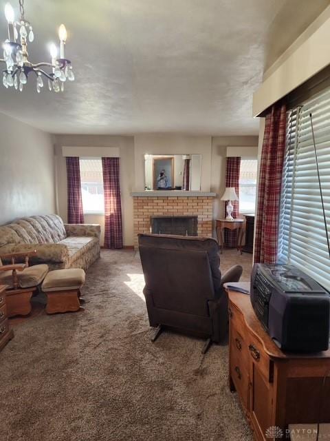 living room with a brick fireplace, carpet, and a chandelier