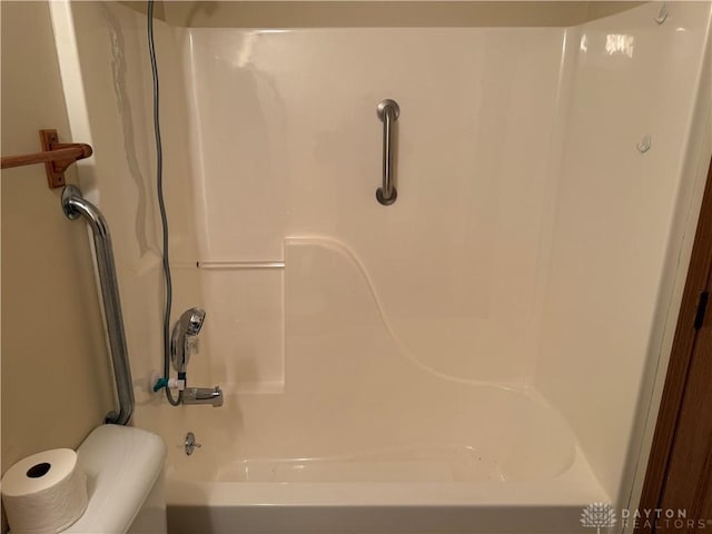 bathroom with shower / bathing tub combination and toilet