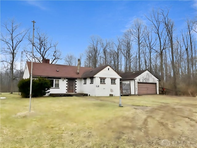 view of front of property with a front yard and a garage