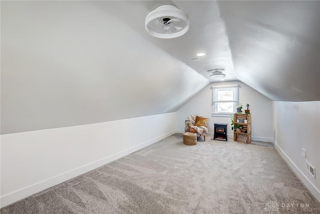 additional living space with carpet and lofted ceiling