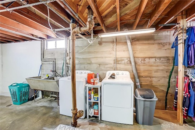 basement featuring sink and separate washer and dryer