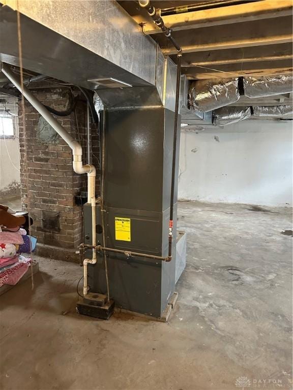 utility room featuring heating unit