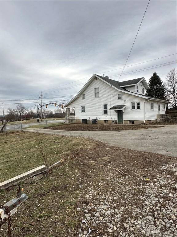 view of property exterior featuring a yard and cooling unit