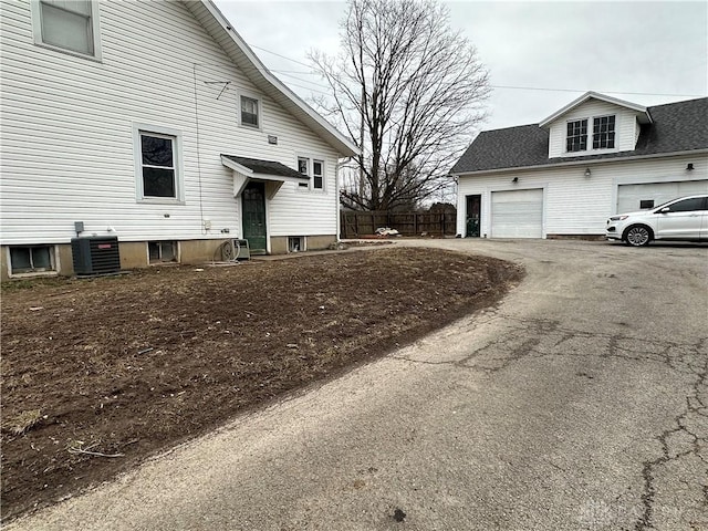 view of home's exterior featuring central AC and a garage