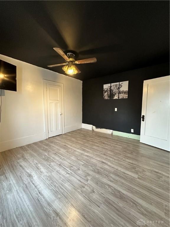 interior space featuring hardwood / wood-style floors and ceiling fan