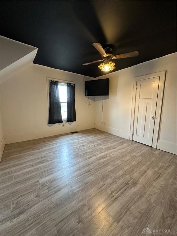 unfurnished bedroom with hardwood / wood-style floors and ceiling fan