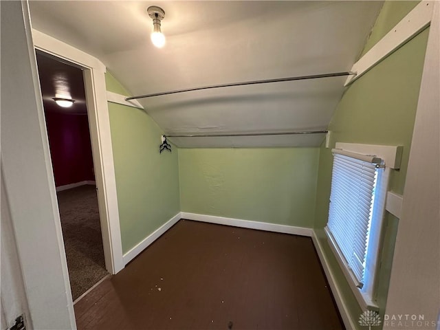 spacious closet featuring lofted ceiling and dark hardwood / wood-style floors