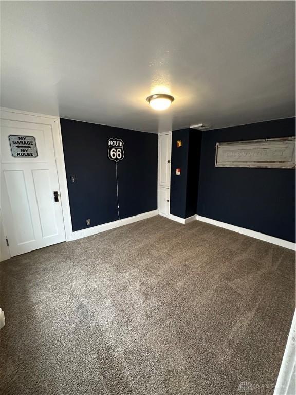 empty room featuring dark colored carpet