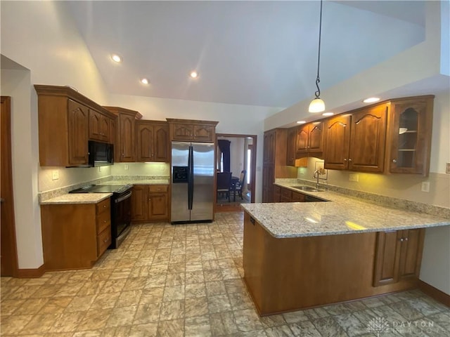 kitchen with hanging light fixtures, light stone counters, black appliances, sink, and kitchen peninsula