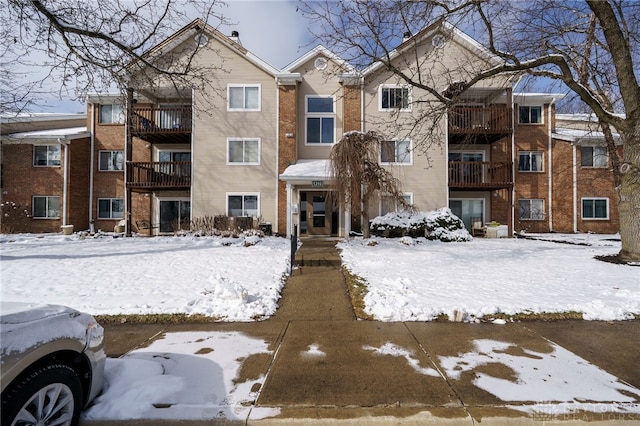 townhome / multi-family property featuring brick siding