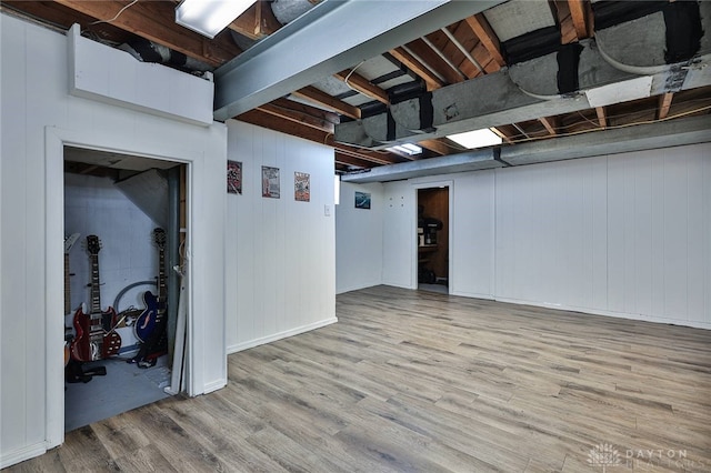 basement with light hardwood / wood-style floors