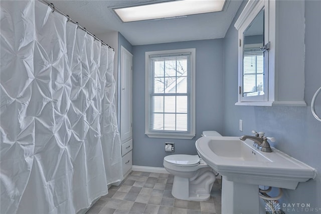 bathroom with a shower with curtain and toilet