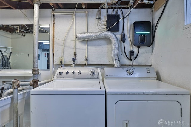 clothes washing area with washing machine and dryer