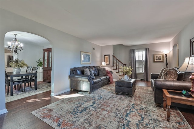 living room with a chandelier and dark hardwood / wood-style floors