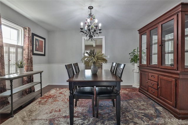 dining space with a notable chandelier and dark hardwood / wood-style floors