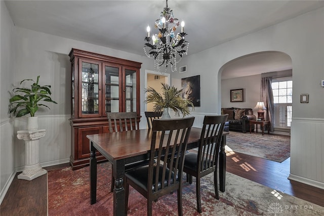 dining room featuring dark hardwood / wood-style floors and a notable chandelier