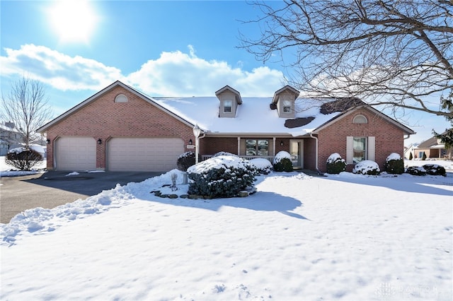 new england style home featuring brick siding and an attached garage