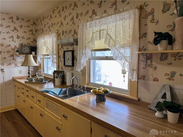 kitchen with wooden counters, sink, dark hardwood / wood-style flooring, and tile walls