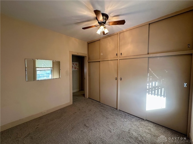 unfurnished bedroom featuring a closet, ceiling fan, and carpet flooring