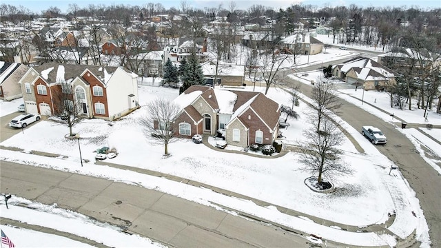 snowy aerial view featuring a residential view