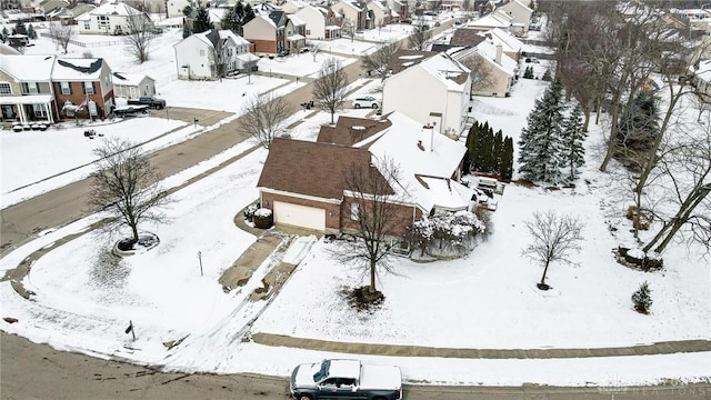 snowy aerial view with a residential view