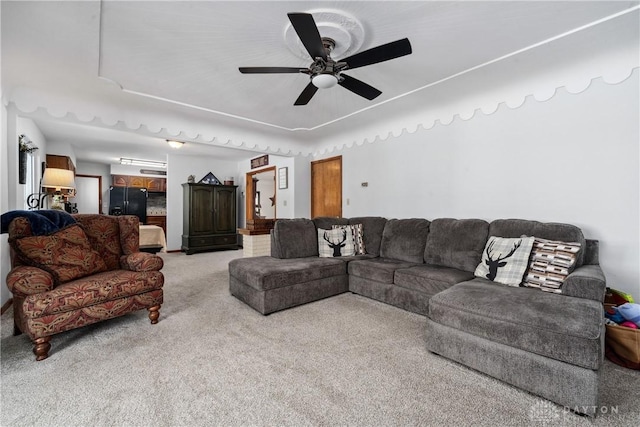 living room with ceiling fan and carpet