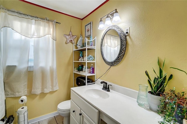 bathroom featuring vanity, tile patterned flooring, and toilet