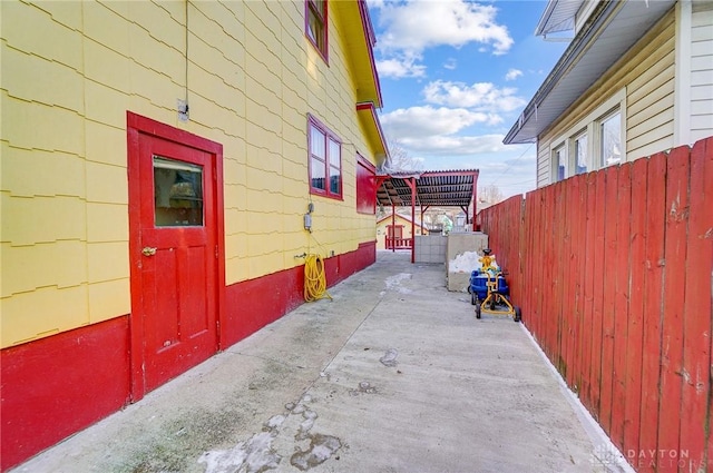 view of side of property with a patio area and fence