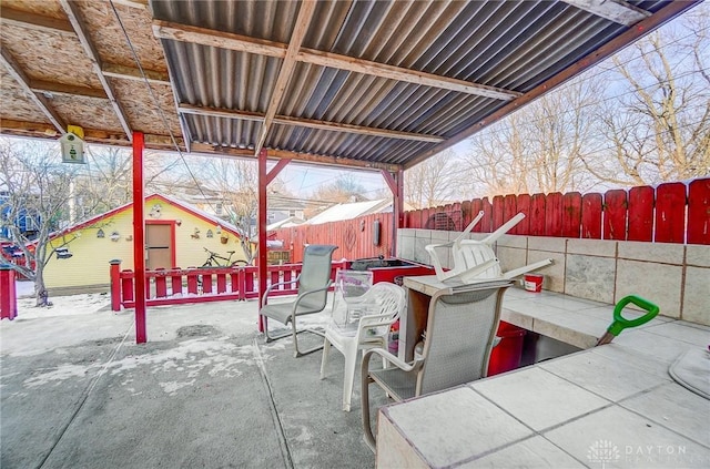 view of patio with an outbuilding and a fenced backyard