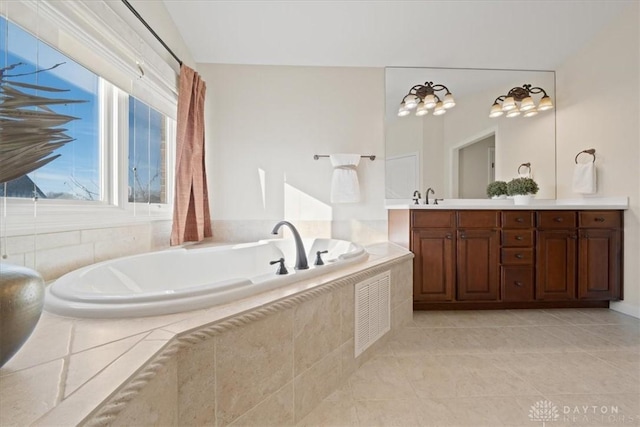 full bath featuring a garden tub, tile patterned floors, visible vents, and vanity