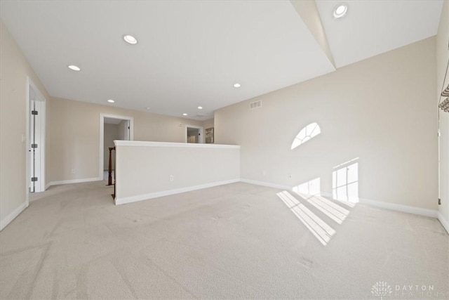 empty room with light colored carpet, visible vents, baseboards, and recessed lighting