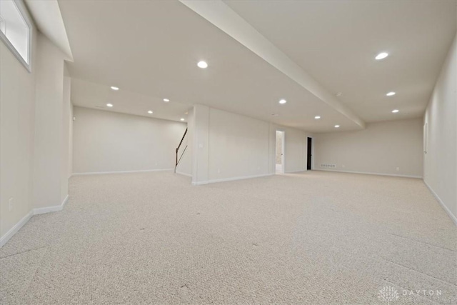 finished below grade area featuring recessed lighting, light carpet, and baseboards