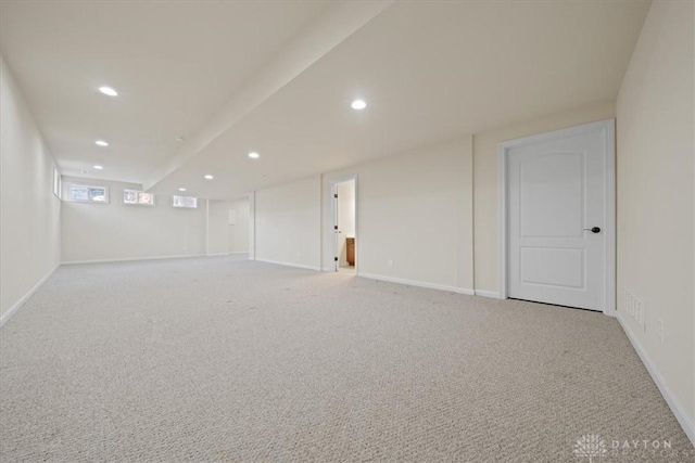 basement with recessed lighting, light carpet, and baseboards