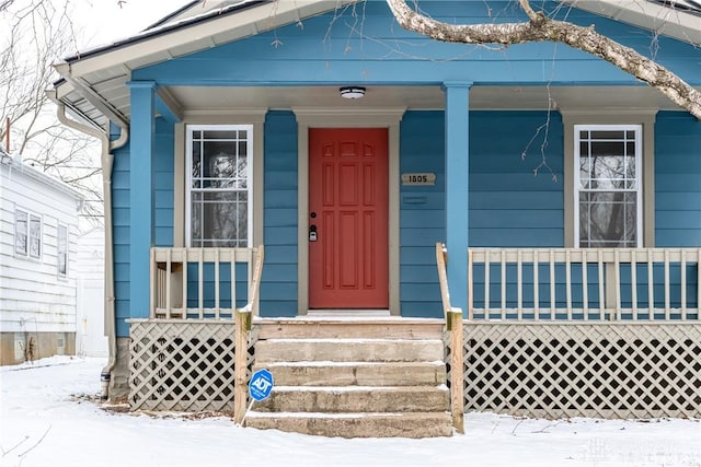 view of snow covered property entrance