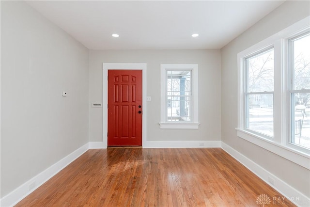 foyer entrance with recessed lighting, baseboards, a wealth of natural light, and wood finished floors