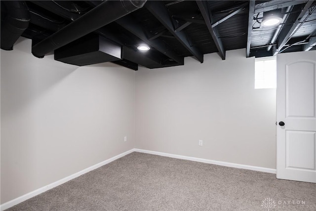 below grade area with carpet floors and baseboards