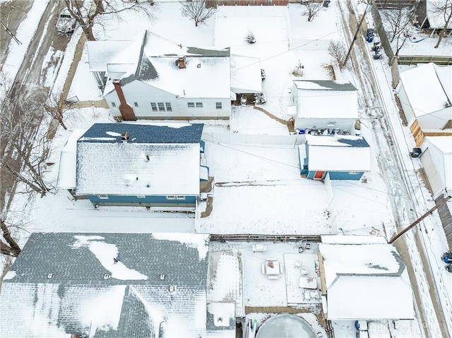 snowy aerial view with a residential view