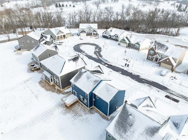 snowy aerial view featuring a residential view