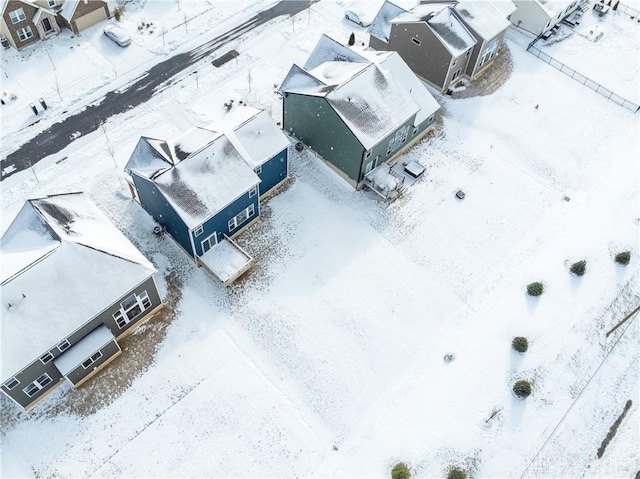 snowy aerial view with a residential view