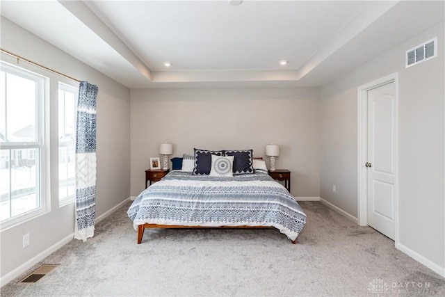 bedroom featuring visible vents, baseboards, and multiple windows