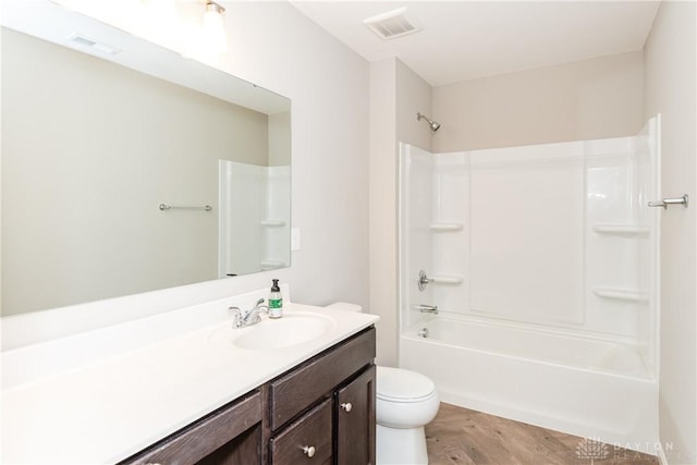 full bathroom with toilet, bathing tub / shower combination, vanity, and visible vents