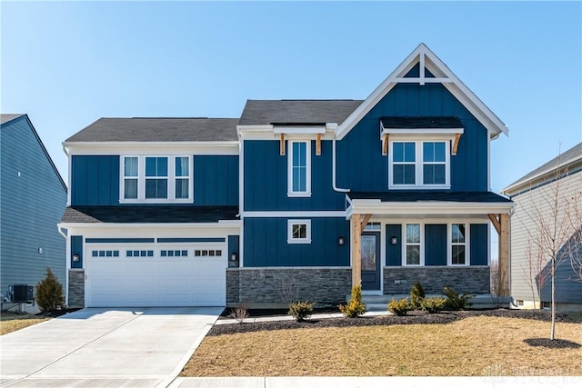 craftsman inspired home with board and batten siding, stone siding, driveway, and central air condition unit