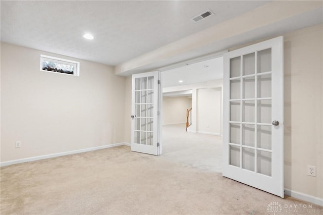 carpeted spare room featuring recessed lighting, visible vents, baseboards, and french doors